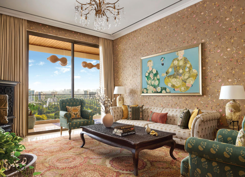 Living room with floral wallpaper, chandelier, sofa and a balcony view