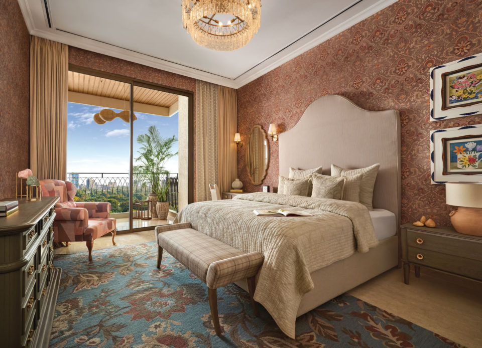 Master bedroom with an upholstered bed, chandelier and balcony view